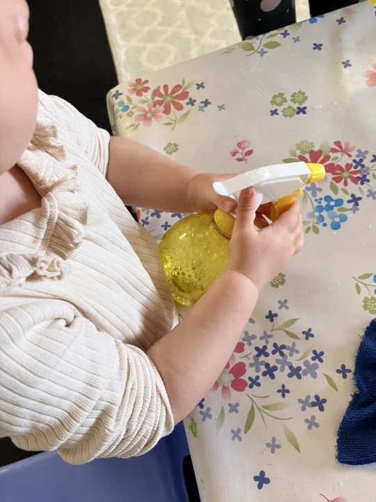 Small hands working carefully with a practical-life activity