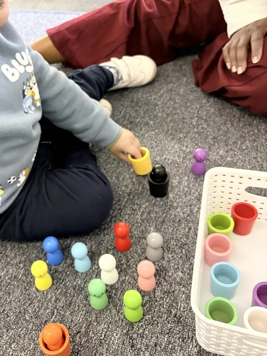 Children sorting colourful objects together