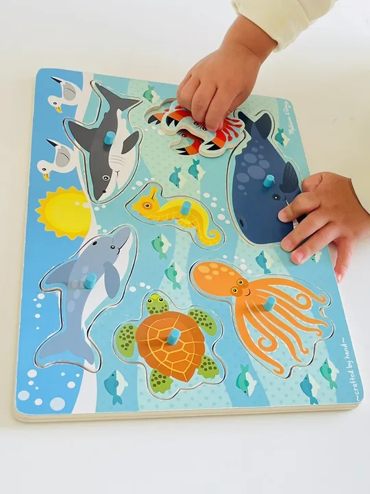 A child completing an ocean-themed puzzle