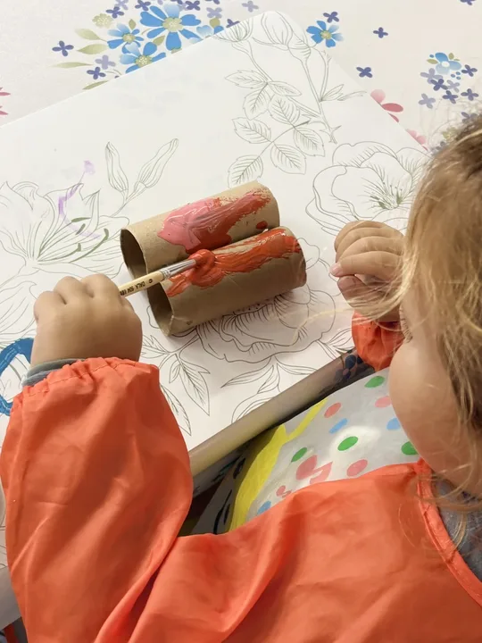 A child painting with rollers