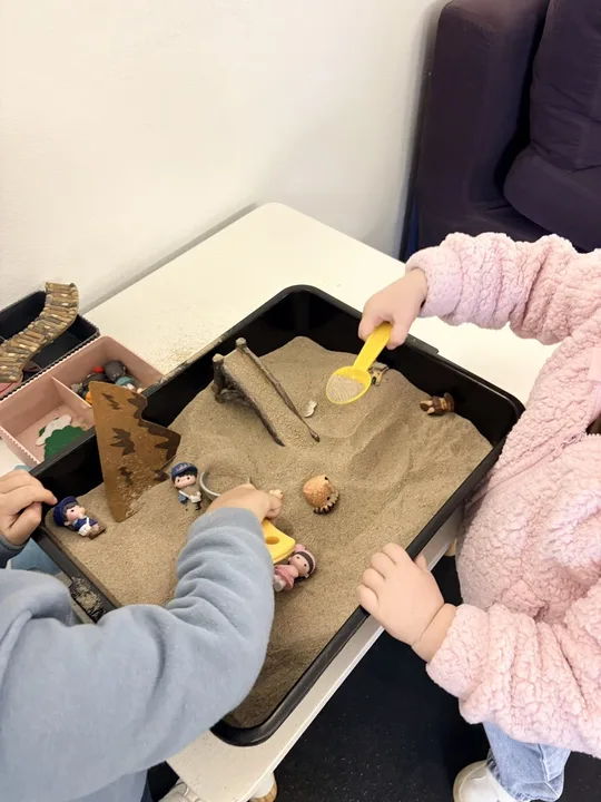 Children sharing a sand-tray activity
