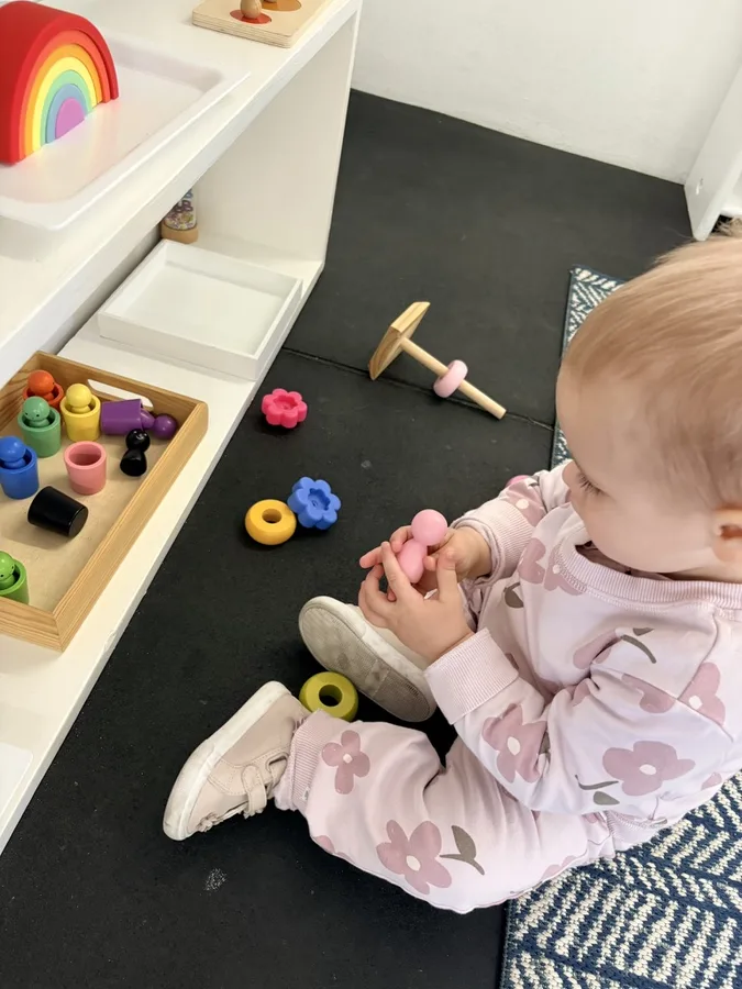 A young child exploring Montessori materials in the prepared environment